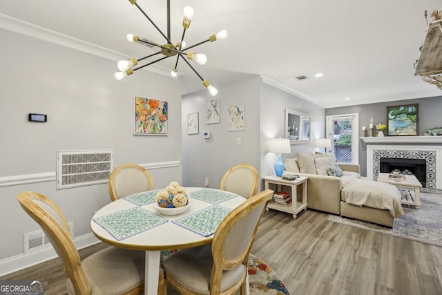 6820 Glenridge Dr Unit C, Sandy Springs, GA 30328 - dining room with a chandelier, wood finished floors, ornamental molding, a tiled fireplace, and recessed lighting