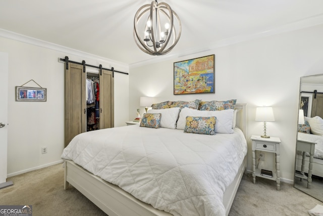 6820 Glenridge Dr Unit C, Sandy Springs, GA 30328 - carpeted bedroom with a barn door, crown molding, a chandelier, a walk in closet, and a closet