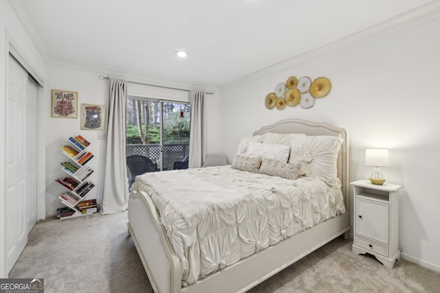 carpeted bedroom with access to outside, a closet, baseboards, and crown molding