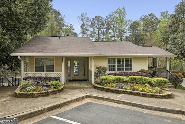 view of front of house featuring covered porch and fence