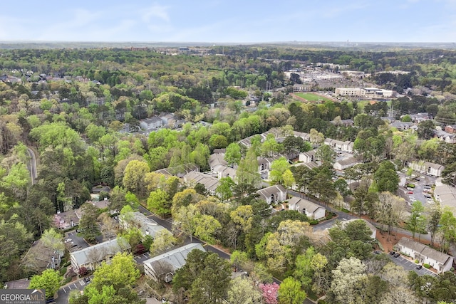 birds eye view of property featuring a wooded view and a residential view