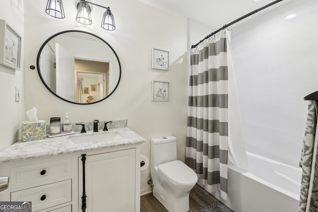bathroom featuring toilet, shower / tub combo with curtain, vanity, and wood finished floors