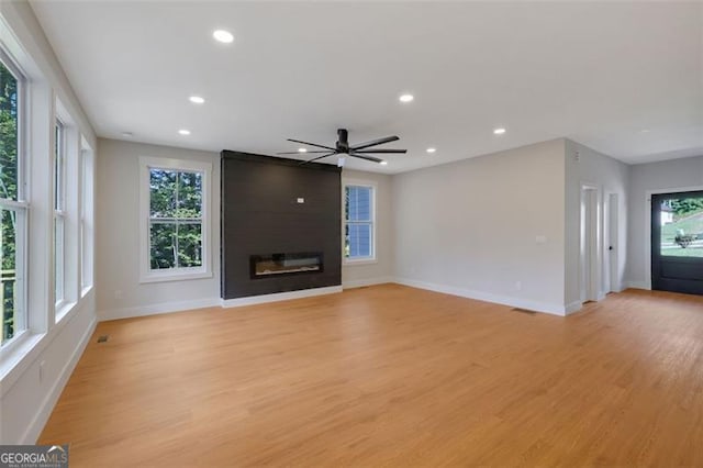 unfurnished living room featuring light wood-style floors, plenty of natural light, and recessed lighting