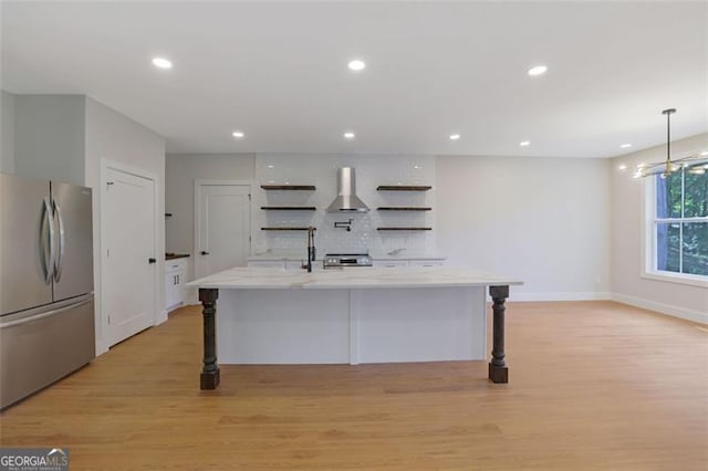 kitchen with freestanding refrigerator, light wood-type flooring, ventilation hood, open shelves, and backsplash