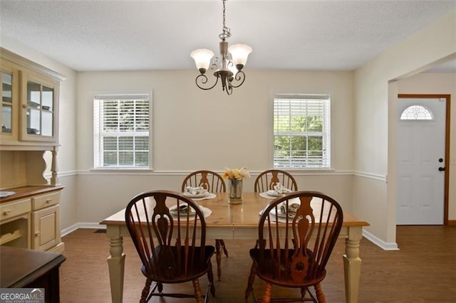 19 Mccrary Ct, Ellijay, GA 30536 - dining area featuring a textured ceiling, wood finished floors, an inviting chandelier, and baseboards