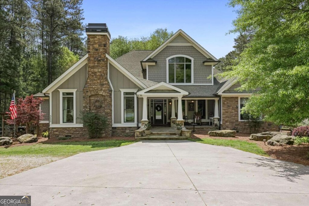 5655 Mccoy Rd NW, Acworth, GA 30101 - craftsman-style home with a chimney, a shingled roof, and stone siding