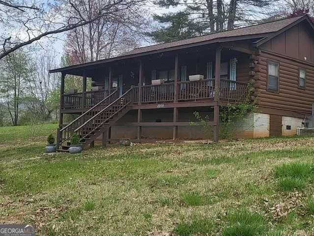 2209 Bell View Ln, Young Harris, GA 30582 - exterior space featuring stairs, log siding, a yard, board and batten siding, and a porch