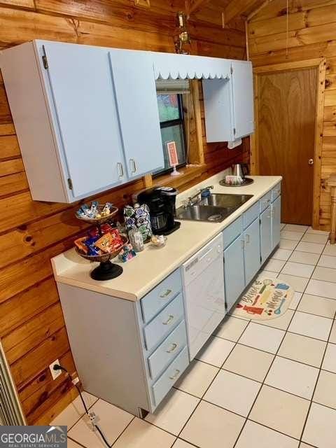 2209 Bell View Ln, Young Harris, GA 30582 - kitchen with blue cabinets, a sink, wood walls, dishwasher, and light countertops
