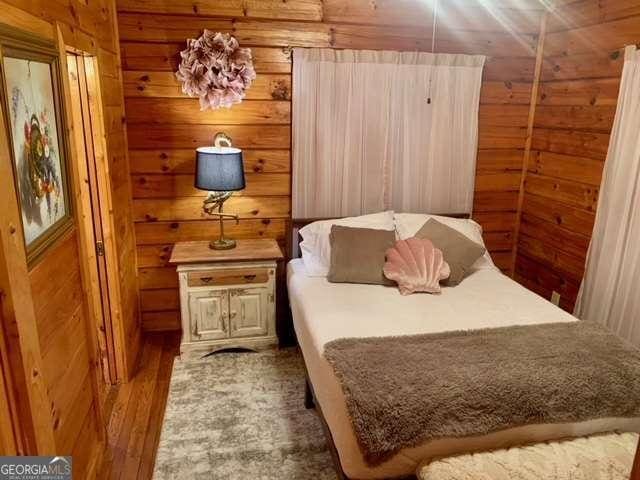 2209 Bell View Ln, Young Harris, GA 30582 - bedroom with wooden walls and wood finished floors