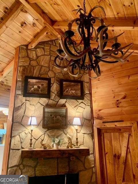 2209 Bell View Ln, Young Harris, GA 30582 - interior details with beam ceiling, wooden ceiling, wooden walls, and an inviting chandelier
