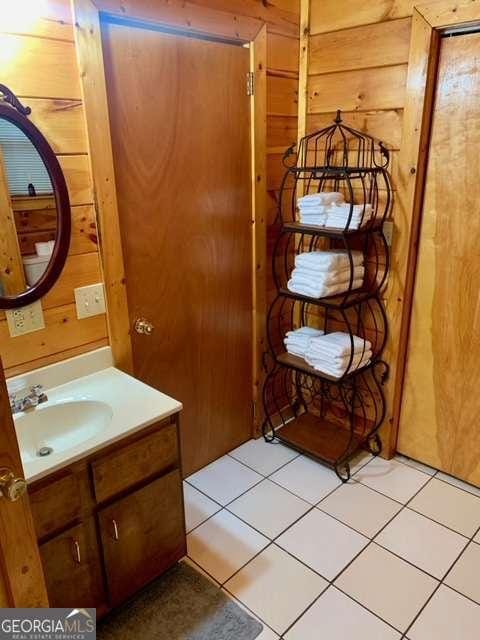 2209 Bell View Ln, Young Harris, GA 30582 - bathroom featuring vanity, tile patterned floors, and wooden walls
