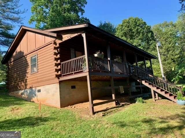 2209 Bell View Ln, Young Harris, GA 30582 - view of side of property featuring a yard, log exterior, crawl space, and stairway