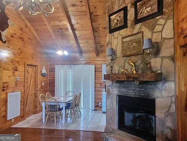 2209 Bell View Ln, Young Harris, GA 30582 - dining room featuring wood finished floors, lofted ceiling with beams, wooden ceiling, wood walls, and visible vents