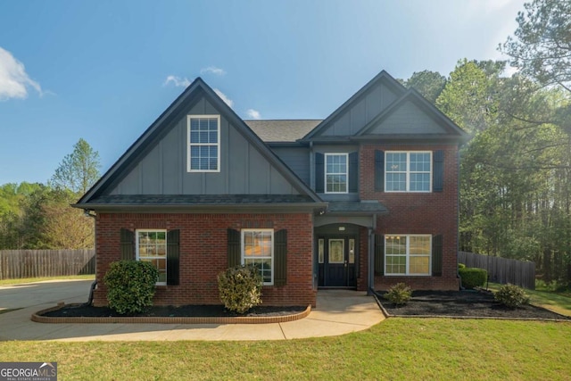 170 Shoal Park Dr, Mcdonough, GA 30252 - view of front of home featuring board and batten siding, a front yard, fence, and brick siding