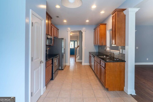 170 Shoal Park Dr, Mcdonough, GA 30252 - kitchen featuring decorative columns, visible vents, brown cabinets, stainless steel appliances, and a sink