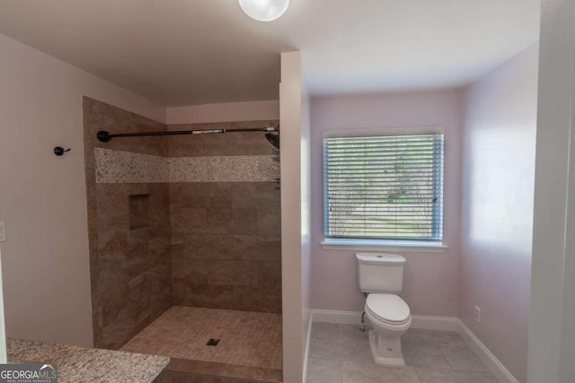 170 Shoal Park Dr, Mcdonough, GA 30252 - full bathroom featuring a tile shower, baseboards, tile patterned flooring, and toilet