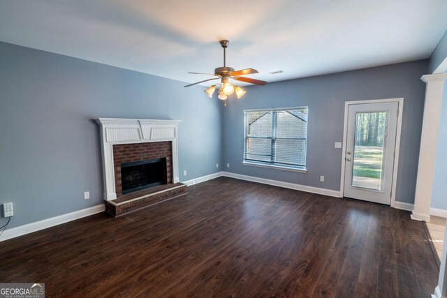 170 Shoal Park Dr, Mcdonough, GA 30252 - unfurnished living room with ceiling fan, a fireplace, visible vents, dark wood-style flooring, and baseboards