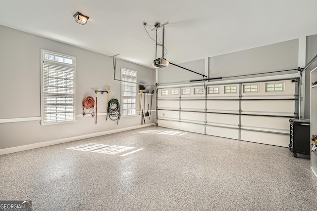 garage featuring baseboards and a garage door opener