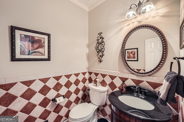 bathroom featuring crown molding, toilet, a sink, tile walls, and a notable chandelier