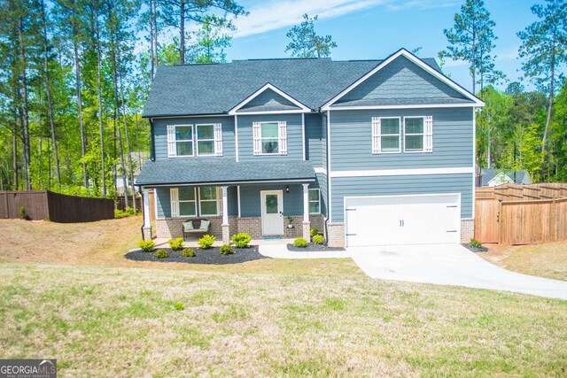 craftsman-style house with a porch, concrete driveway, fence, a garage, and a front yard