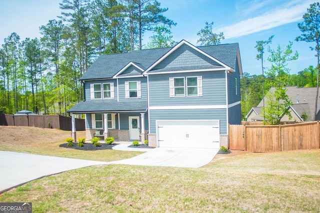 craftsman-style home featuring concrete driveway, a front lawn, fence, and a porch