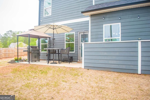 exterior space featuring a yard, a shingled roof, a patio, and fence