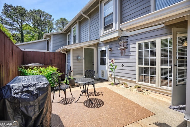 view of patio / terrace featuring grilling area and fence