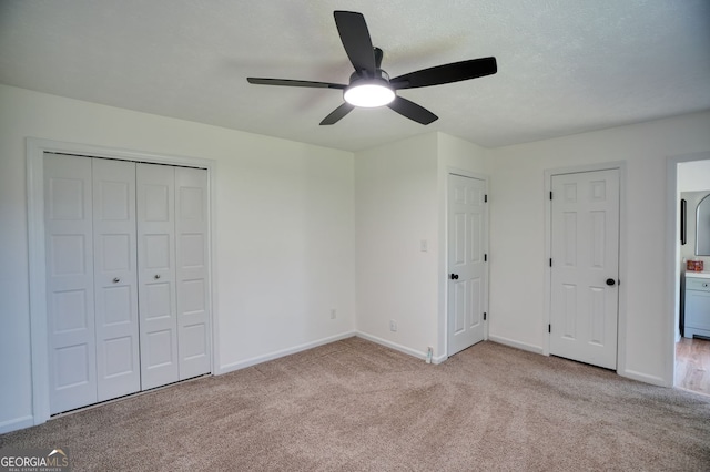 unfurnished bedroom featuring carpet flooring, baseboards, and ceiling fan