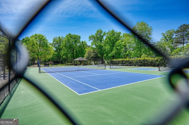 view of sport court featuring community basketball court and fence