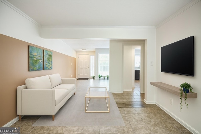 living area featuring crown molding, baseboards, and light tile patterned floors