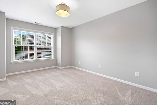 unfurnished room featuring visible vents, baseboards, and carpet floors