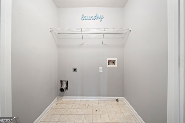 clothes washing area featuring baseboards, hookup for an electric dryer, hookup for a washing machine, and laundry area