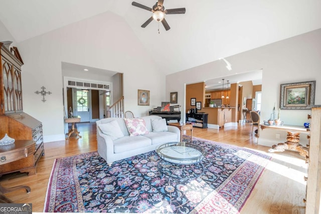 20 Rivercreek Xing, Kingston, GA 30145 - living area featuring high vaulted ceiling, a ceiling fan, light wood-style flooring, and stairs