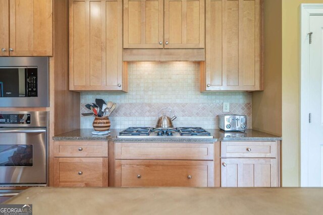 20 Rivercreek Xing, Kingston, GA 30145 - kitchen with stainless steel appliances, decorative backsplash, and stone counters