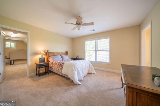 bedroom featuring baseboards, multiple windows, and light carpet