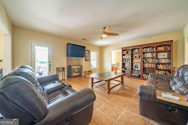 living room featuring light tile patterned floors and ceiling fan