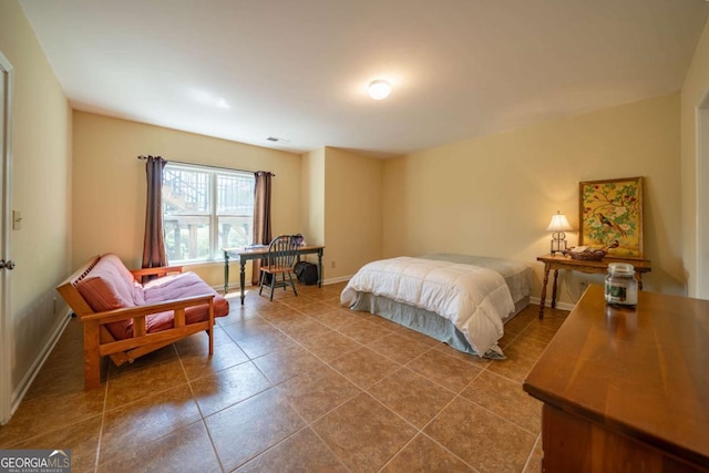 tiled bedroom featuring baseboards and visible vents