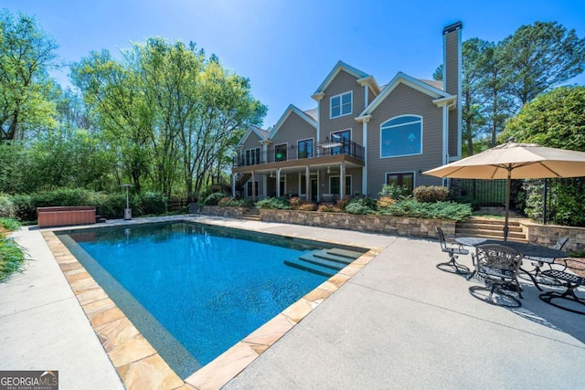 pool featuring a patio and a hot tub