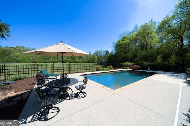 view of pool with a fenced in pool, a patio, and fence