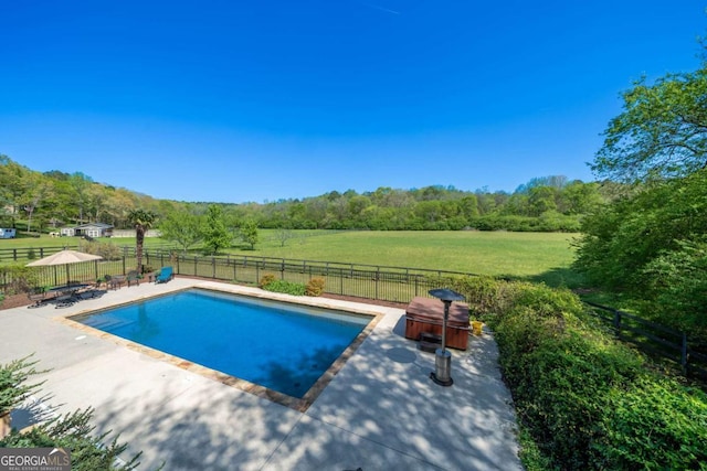 view of pool featuring a patio area, a gazebo, a fenced backyard, a view of trees, and a fenced in pool