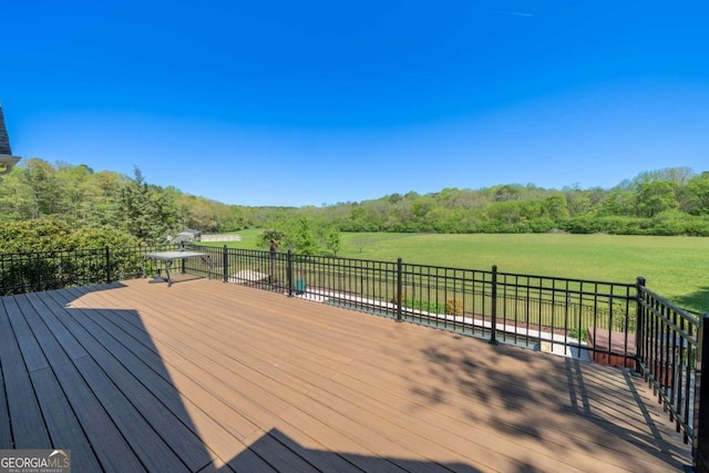 wooden deck with a wooded view