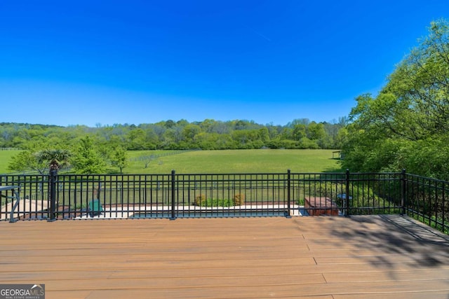 wooden terrace featuring a lawn