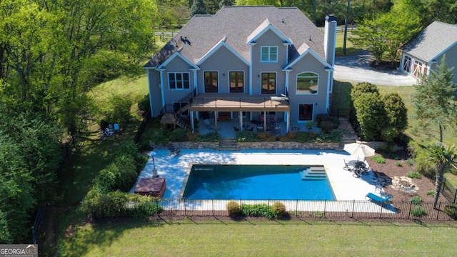 back of property featuring fence private yard, a lawn, a patio area, stairs, and a fenced in pool