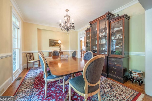 20 Rivercreek Xing, Kingston, GA 30145 - dining space featuring a chandelier, wood finished floors, and crown molding