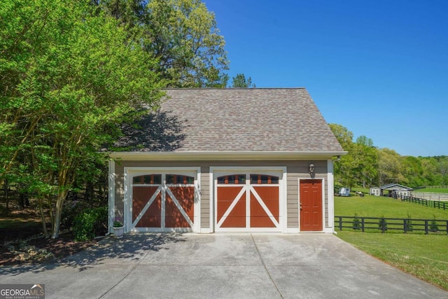 view of outdoor structure featuring an outbuilding and fence