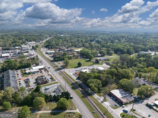 bird's eye view with a wooded view