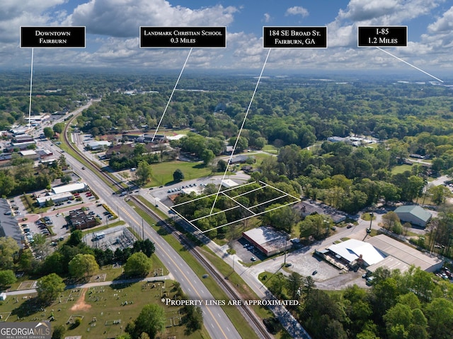 birds eye view of property featuring a view of trees