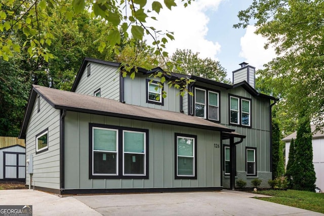 view of front of home featuring board and batten siding and a chimney
