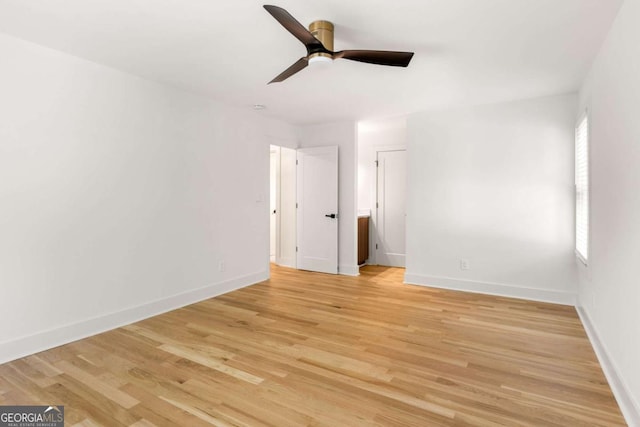 unfurnished bedroom featuring light wood-type flooring, ceiling fan, and baseboards