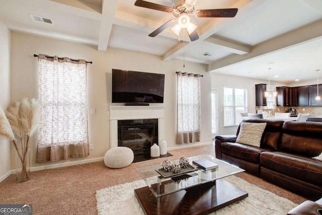 living room with coffered ceiling, baseboards, and visible vents